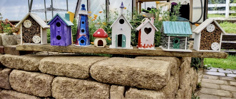 unique and colorful birdhouses in a row